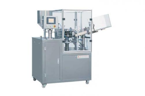 Metal tube filling and sealing machine